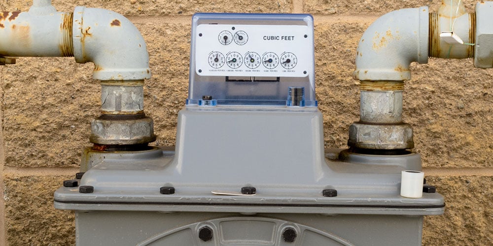 Why are gas meters temperature and pressure compensated?